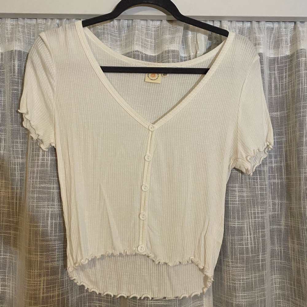 White button up shirt with frilly edges